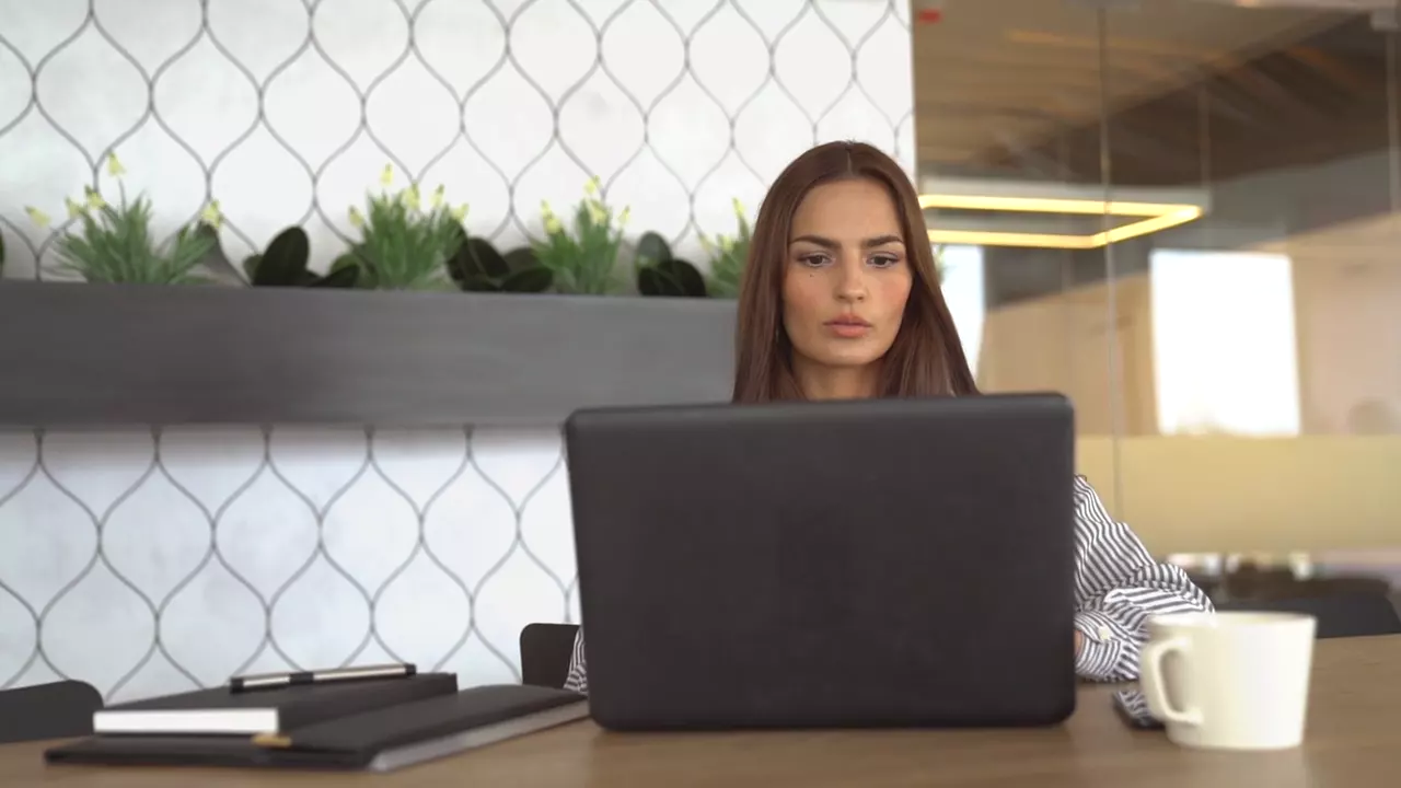 Businesswoman working on a laptop, hero video poster